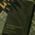 Femme souriante révisant ses finances avec un ordinateur et un carnet.